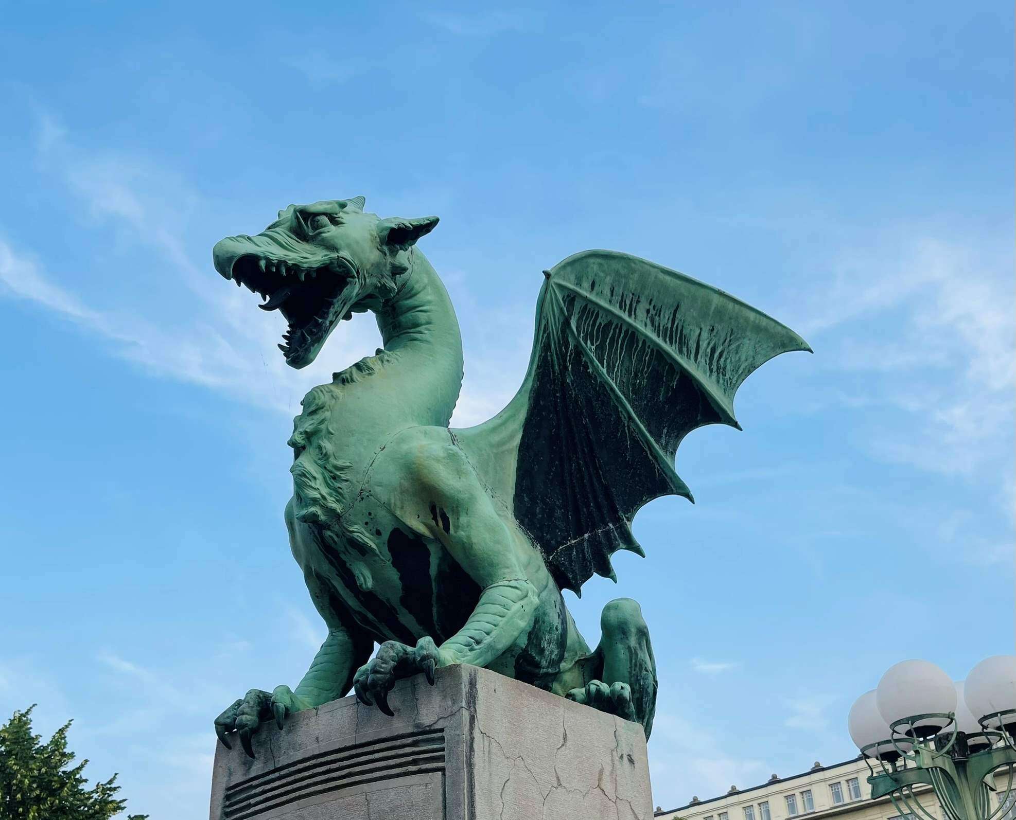 Fierce green dragon statue, on pedestal guarding the city of Ljubljana